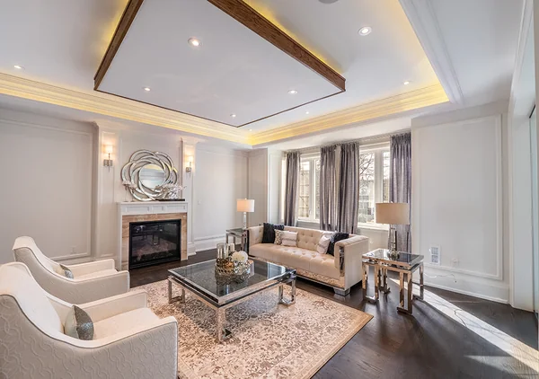 Bevdale Road: Living room seating beneath a recessed ceiling beside a fireplace