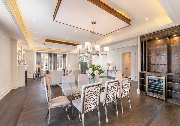Bevdale Road: Dining table beside built-in cabinets and beverage storage