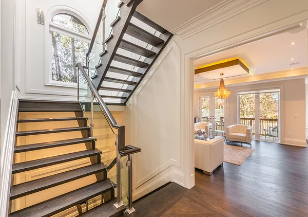 Bevdale Road: Wood staircase with glass balustrade and tall arched window