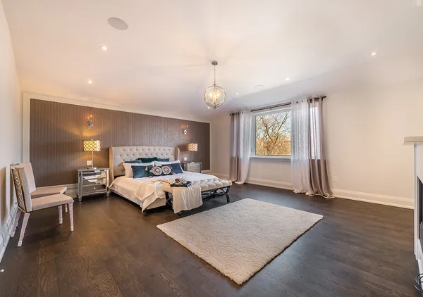 Bevdale Road: Bedroom with upholstered bed, rug and wood floor