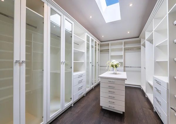 Bevdale Road: Walk-in wardrobe with white shelving and overhead skylight