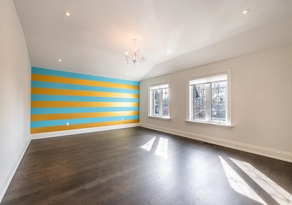 Bevdale Road: Empty room with blue and yellow striped accent wall