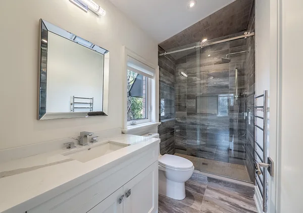 Bevdale Road: Bathroom with long vanity and dark tiled shower