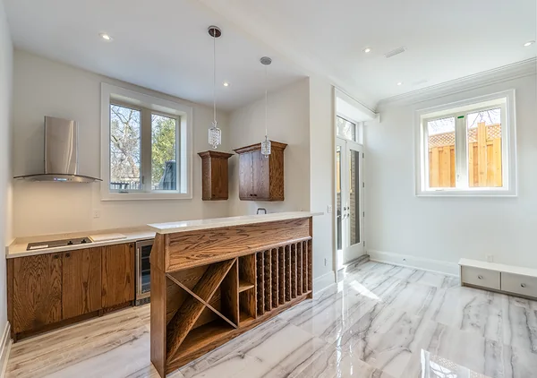 Bevdale Road: Lower-level kitchenette with wood cabinetry and stone counter