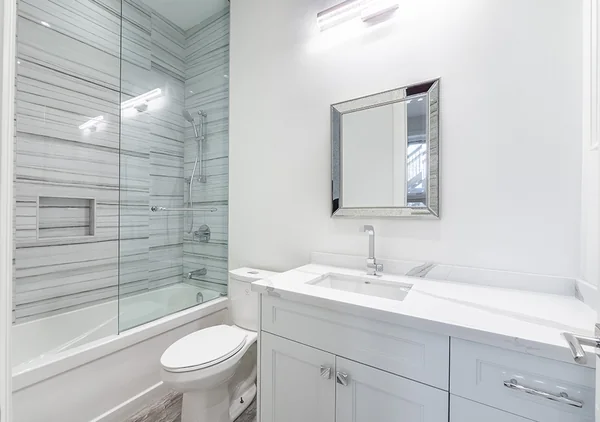Bevdale Road: Bathroom with white vanity and pale tiled bath surround