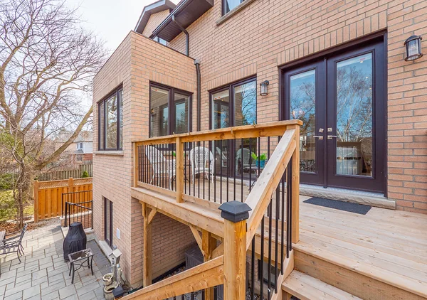 Bevdale Road: Rear brick exterior beside timber deck and stairs