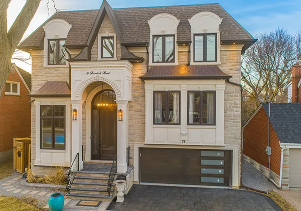 Bevdale Road: Front exterior and arched entry illuminated at dusk