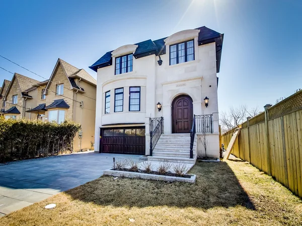 Joicey Boulevard 2: Front exterior with pale facade, arched entrance and paved driveway