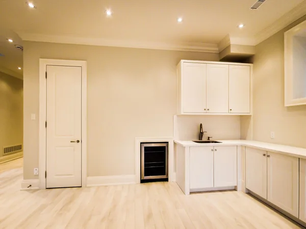 Joicey Boulevard 2: Lower-level kitchenette with white cabinetry and beverage fridge