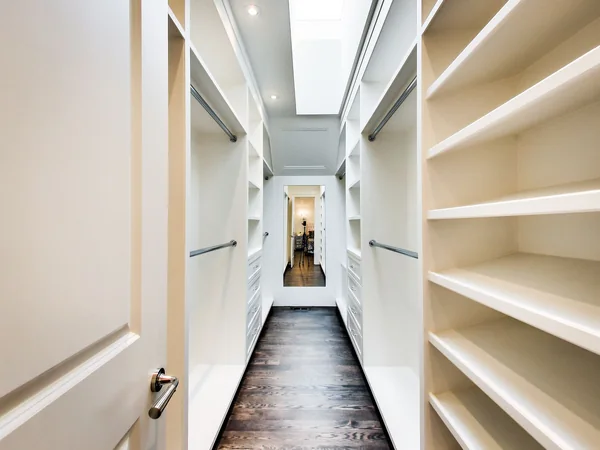 Joicey Boulevard 2: Walk-in wardrobe lined with white shelves beneath a skylight