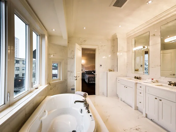 Joicey Boulevard 2: Bathroom with inset bathtub and long white vanity