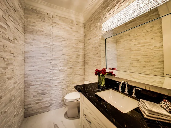 Joicey Boulevard 2: Powder room with stone-textured walls and dark vanity counter