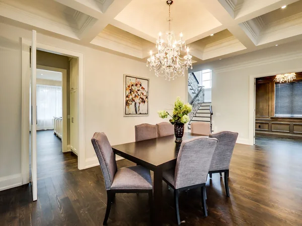 Joicey Boulevard 2: Dining table and upholstered chairs beneath a chandelier