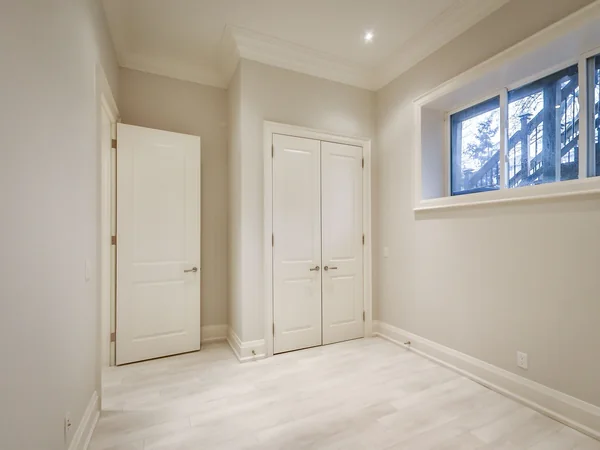 Joicey Boulevard 2: Empty lower-level room with wood-effect floor and high window