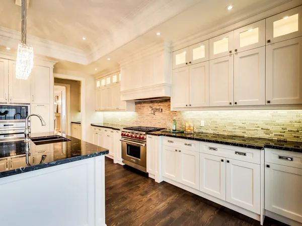 Joicey Boulevard 2: White kitchen cabinets, range and illuminated backsplash