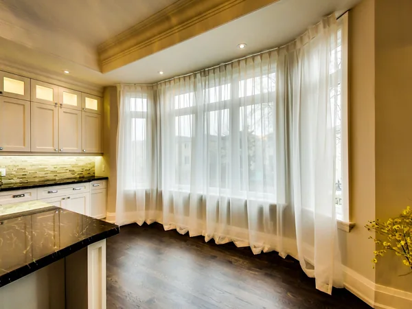 Joicey Boulevard 2: Kitchen window with sheer curtains beside the island