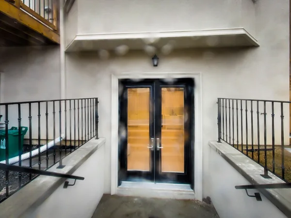 Joicey Boulevard 2: Lower-level rear doors between metal handrails