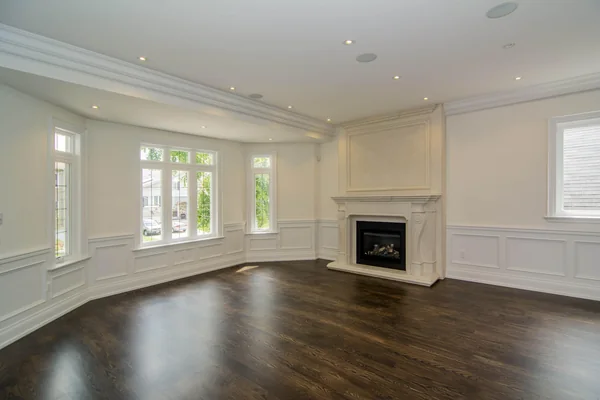 Joicey Boulevard: Living room with white wall panelling, fireplace and dark wood floor