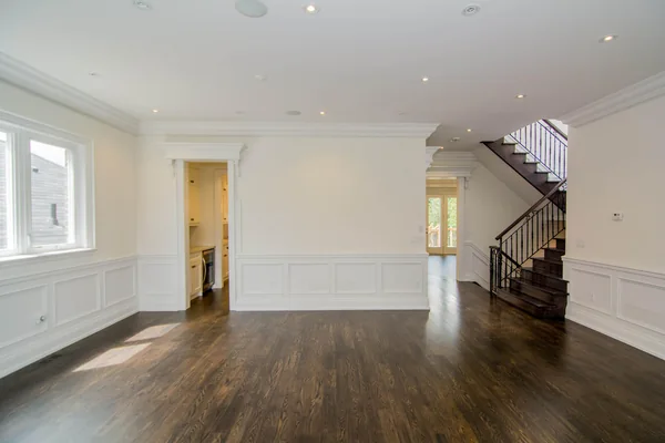 Joicey Boulevard: Living room opening toward the kitchen and wood staircase