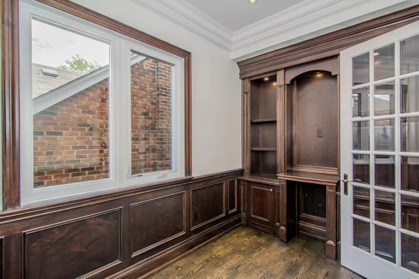 Joicey Boulevard: Wood-panelled room with built-in cabinetry and a large window
