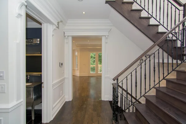 Joicey Boulevard: Wood staircase with metal balusters and a hallway to the kitchen