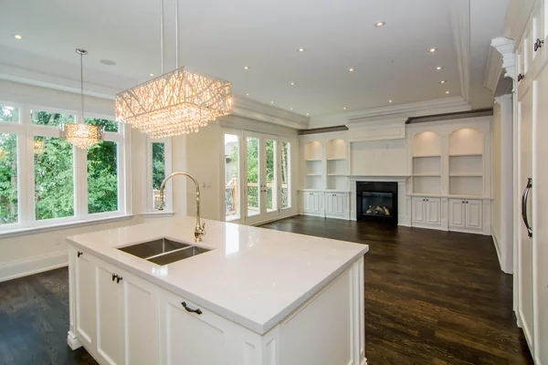 Joicey Boulevard: Kitchen island looking toward a fireplace and rear windows