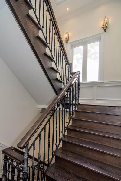 Joicey Boulevard: Wood staircase and metal railings beside tall windows