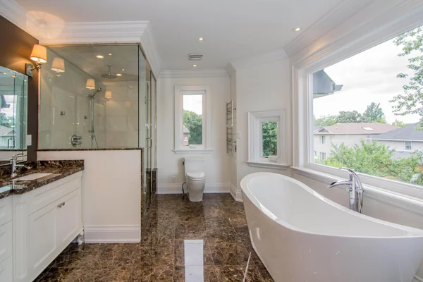 Joicey Boulevard: Bathroom with freestanding tub, glass shower and rear windows