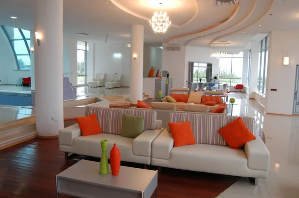 Kazakhstan–Kapchegai: Commercial lounge with white sofas, orange cushions and chandeliers