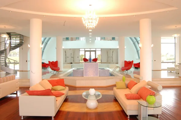 Kazakhstan–Kapchegai: Lounge seating with orange cushions beside mirrored columns