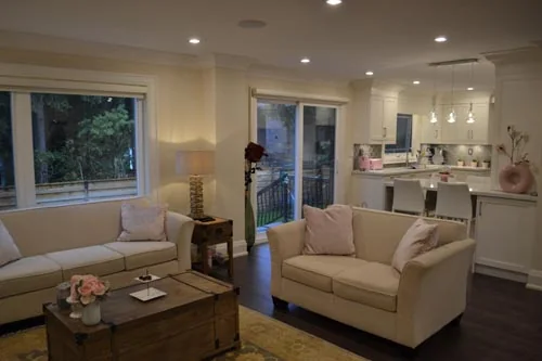Nevada Avenue: Living area with white seating, wood flooring and an open kitchen