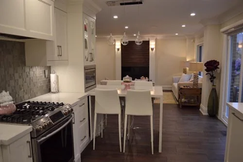 Nevada Avenue: White kitchen with gas range and island seating