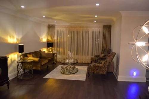 Nevada Avenue: Living room with sofa, lounge chairs and full-height curtains