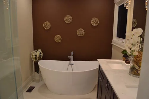 Nevada Avenue: Freestanding oval bathtub beside a dark accent wall