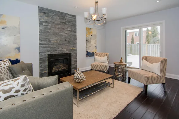 Tilman Circle: Family room with stone fireplace and glazed rear doors
