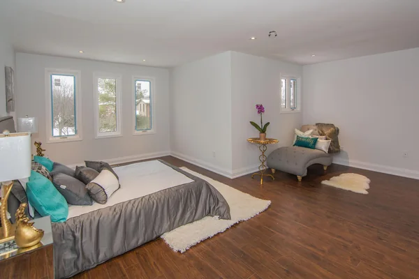 Tilman Circle: Bedroom with wood floor and three windows