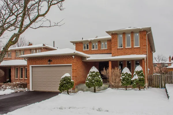 Tilman Circle: Front exterior of the brick house in snow
