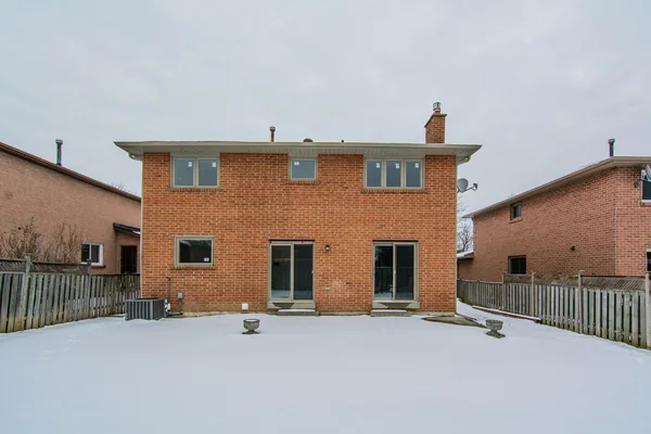 Tilman Circle: Rear brick exterior and snow-covered garden